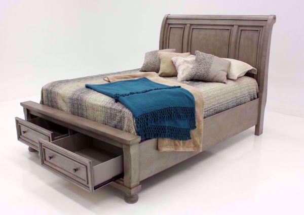 Light Gray Lettner Queen Size Sleigh Bed by Ashley Furniture at an Angle with the Footboard Drawers Open | Home Furniture Plus Bedding