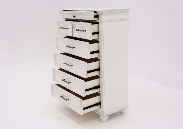 Distressed White Kanwyn Chest of Drawers by Ashley at an Angle with the Drawers Open | Home Furniture Plus Mattress