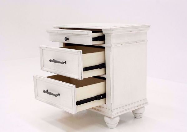 Distressed White Kanwyn 3 Drawer Nightstand by Ashley at an Angle With the Drawers Open | Home Furniture Plus Mattress