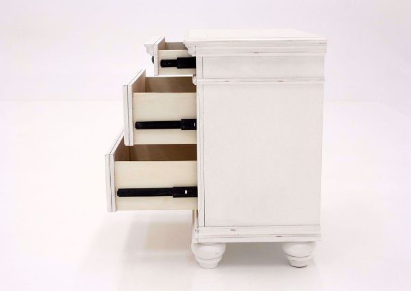Distressed White Kanwyn 3 Drawer Nightstand by Ashley Showing the Side View With the Drawers Open | Home Furniture Plus Mattress